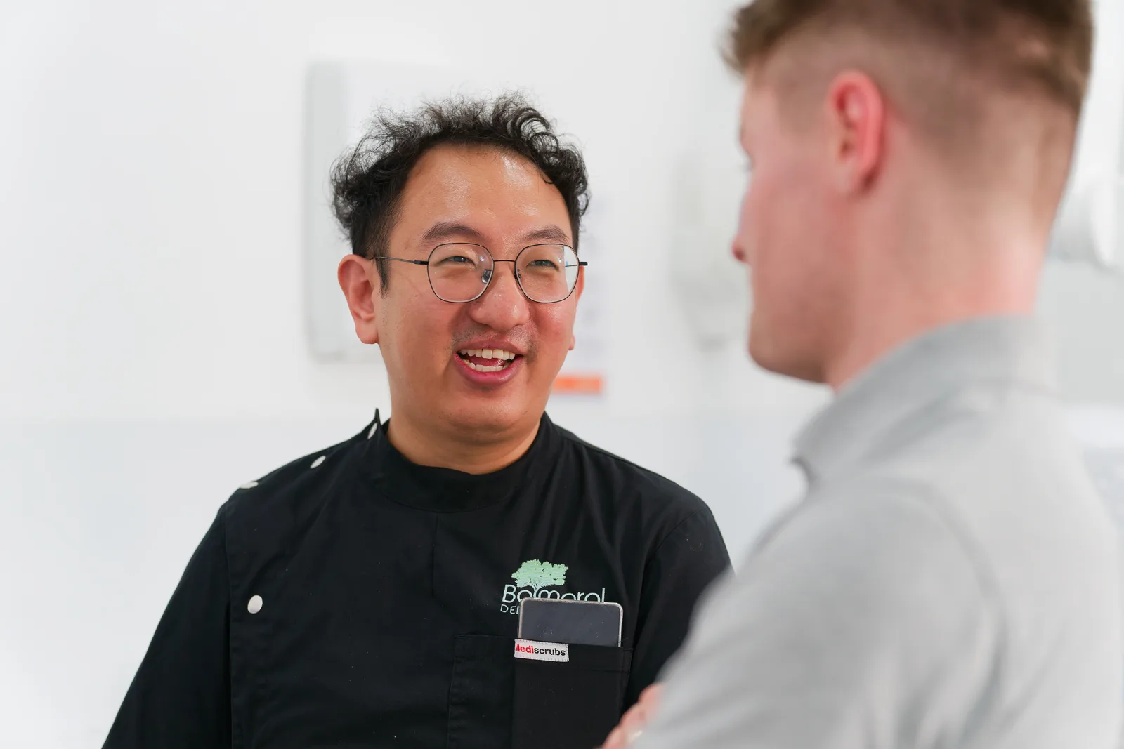 Dentist speaking with a person during a consultation at the clinic