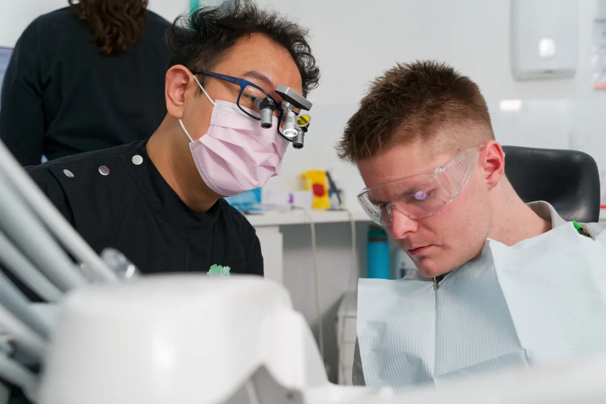 Clinician reviewing implant treatment with a patient in the chair