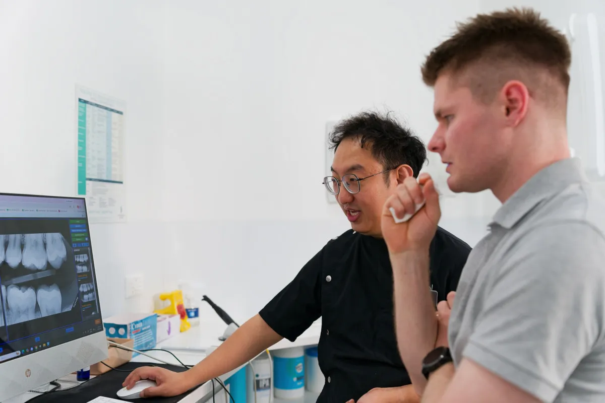 Clinician reviewing dental scans during an implant planning appointment